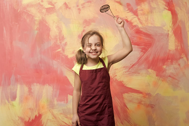 small happy girl chef in cook apron holding cooking tool - Foto, Bild