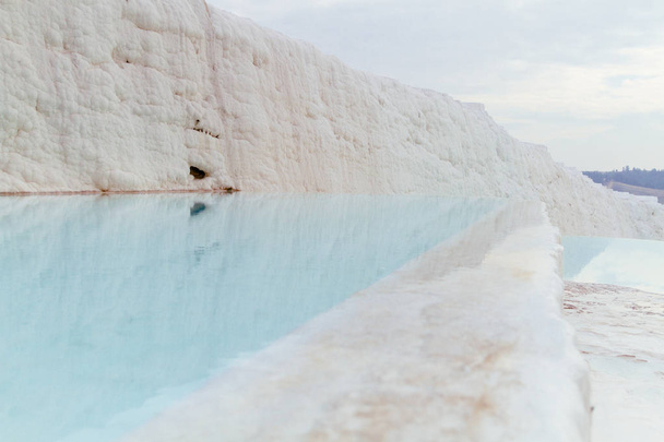 View of white travertine limestone mountain and pool of Pamukkale, Turkey - Photo, Image