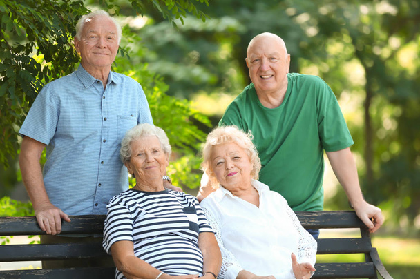 Elderly people spending time together in park - Foto, afbeelding