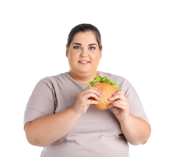 Overweight woman with hamburger on white background - Fotoğraf, Görsel