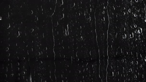 Patrón de gotas sobre fondo negro, video 4k
 - Metraje, vídeo