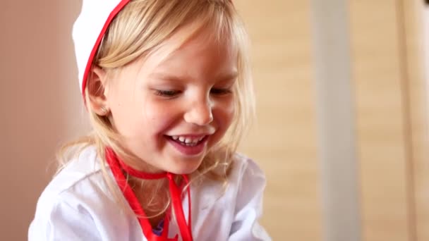 Portrait of smiling girl in doctors clothes - Materiał filmowy, wideo