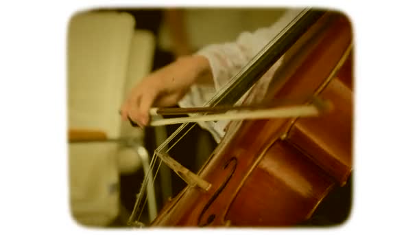 Female hand with a bow plays on a double bass. 8mm retro style film. - Footage, Video