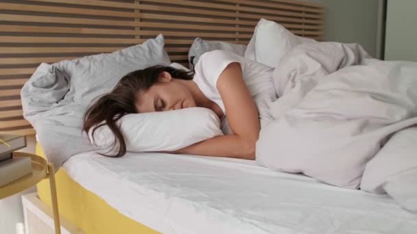 fiatal nő alszik az ágyában - Felvétel, videó