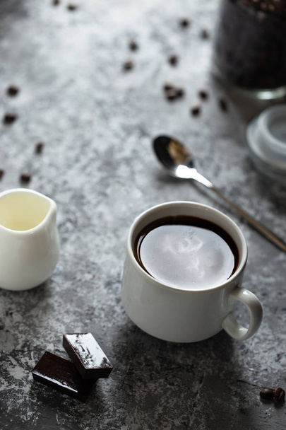 Cup of coffee with milk and chocolate on dark background - Foto, imagen
