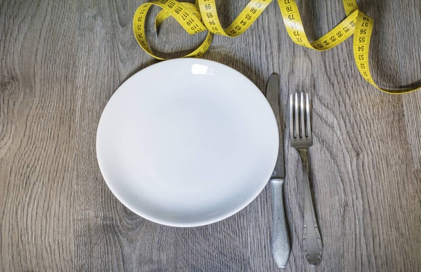 Weight Loss and Diet Concept with Empty Plate with Measuring Tape - Photo, Image