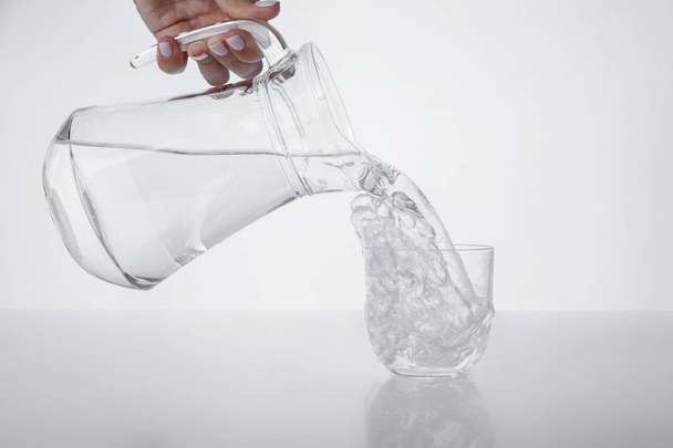 A pitcher and a glass. Pure water. - Zdjęcie, obraz