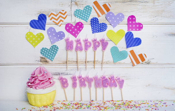 Pink Happy Birthday Candles,Cupcake and Colorful Hearts on a White Wooden Background - Zdjęcie, obraz