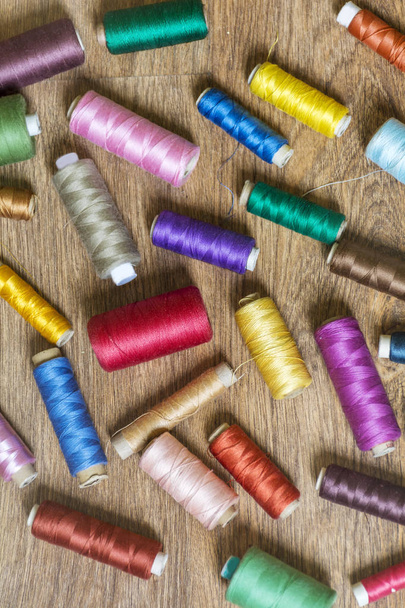 Multi Colored Thread Yarns Frame on Wooden Background - Fotó, kép