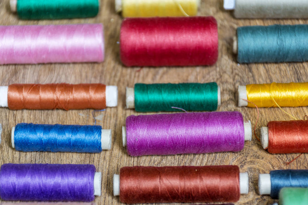 Multi Colored Thread Yarns Frame on Wooden Background - Fotó, kép