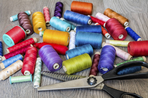 Multi Colored Thread Yarns and Vintage Scissors on Wooden Background - Φωτογραφία, εικόνα