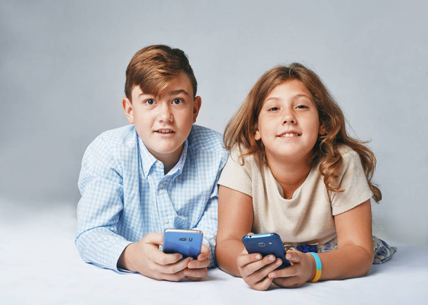 a very happy kids with smartphones. Stusio portrait - Foto, imagen