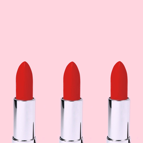 Group of red lipsticks on pink background. - Photo, Image