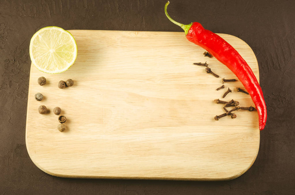 spices, fresh ingredients and empty cutting board/spices, fresh ingredients and empty cutting board. Top view - Zdjęcie, obraz