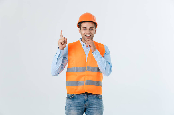 Visionary architect or engineer looking up and thinking about new projects. Wearing yellow hardhat and reflective vest isolated on white background. - Foto, imagen