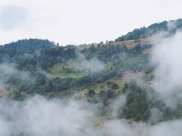 Fog at the village in the carpatian mountains  - Φωτογραφία, εικόνα