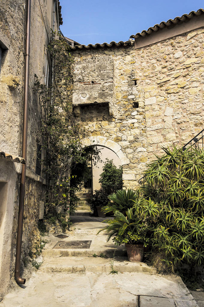 Pequeno beco na vila medieval Provençal de Roquebrune Cap Martin na Riviera Francesa
 - Foto, Imagem