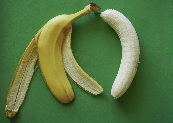 white banana and yellow pill on paper background - Fotografie, Obrázek