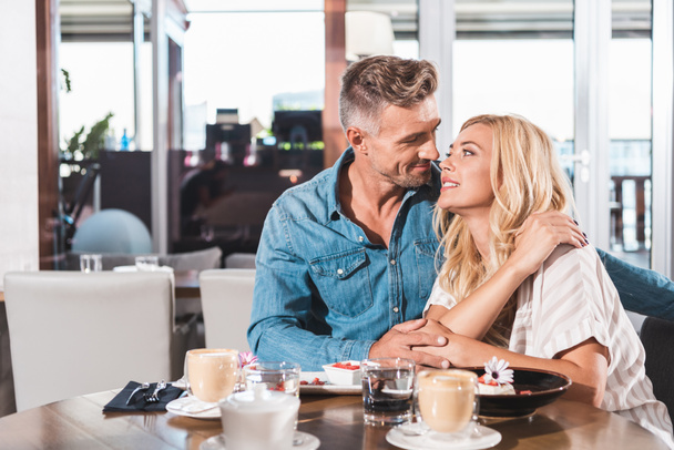 affectionate couple going to kiss during date in cafe - Φωτογραφία, εικόνα