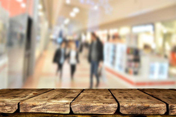 Empty wooden  table with blurred shopping mall background - Photo, Image