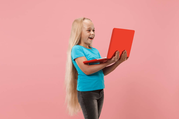 The happy child with red laptop on pink - Zdjęcie, obraz