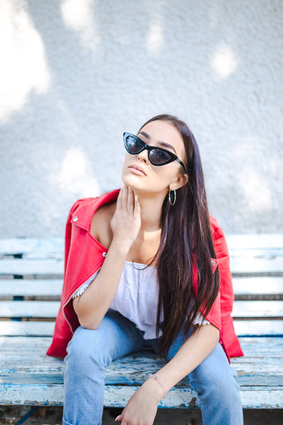 Portrait of beautiful woman sitting on the bench - Photo, image