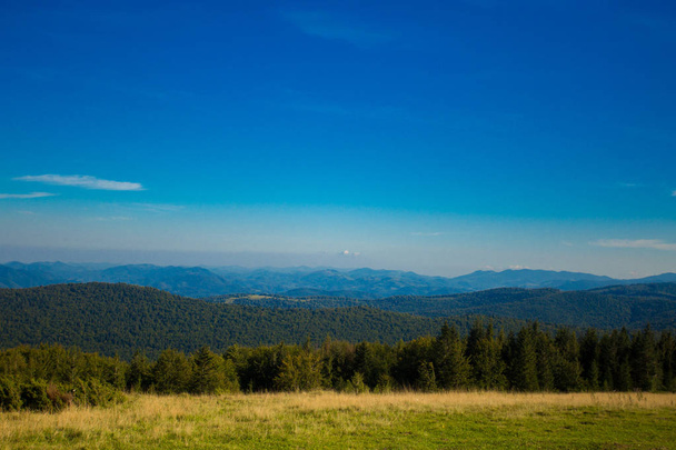 Beautiful landscape of summer mountains with blue sky. Autumn mountain village panoramic landscape - Zdjęcie, obraz