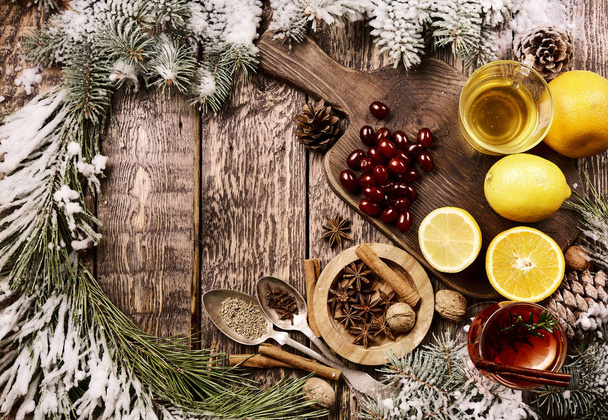 Flat lay ingredients forChristmas hot mulled red wine with spices and fruits on a wooden rustic table with spruce branches. Traditional hot drink, mulled wine or grog at Christmas time. Copyspace top view - Zdjęcie, obraz