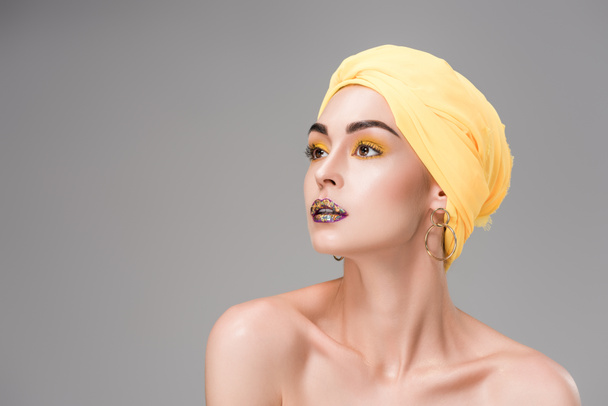 beautiful naked woman in yellow turban looking away isolated on grey - Photo, Image