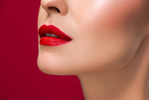 cropped shot of young woman with juicy red lips isolated on red - Фото, изображение