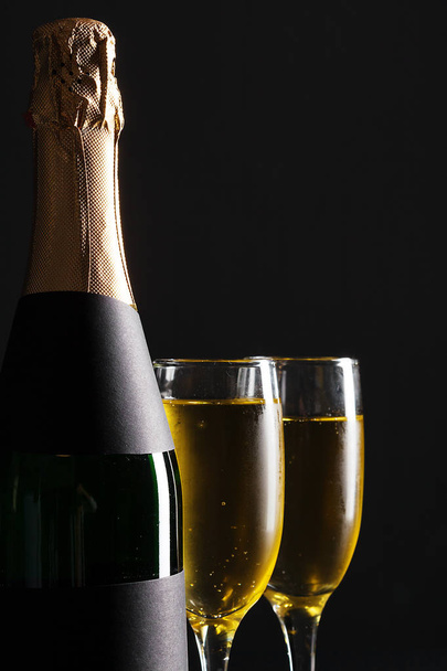 champagne wine glasses and bottle on black background - Fotoğraf, Görsel