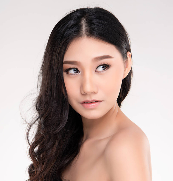 Beautiful Young Asian Woman with Clean Fresh Skin look away, Girl beauty face care. Facial treatment, Cosmetology, beauty and spa. - Zdjęcie, obraz