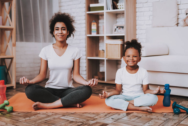 Happy Girl and Mother in Sportswear Training. People Training in Studio. Smile Girl and Youga. Work with Little Girl. Training with People. Yoga with Family. Relaxation with Daughter. Mother Training. - Photo, image