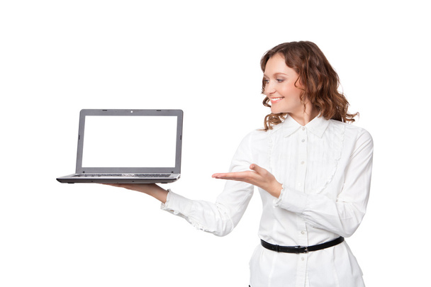 Portrait of a pretty young businesswoman holding a laptop - Photo, image