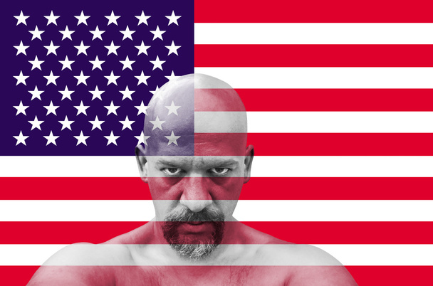 American patriot looking at you with USA flag in the background - Zdjęcie, obraz