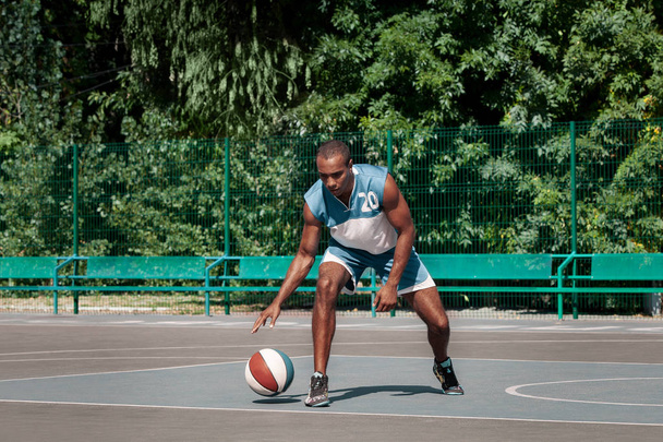 Picture of young confused african basketball player practicing - Valokuva, kuva