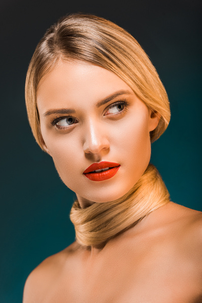 portrait of attractive woman with red lips and blond hair over neck on dark backdrop - Valokuva, kuva