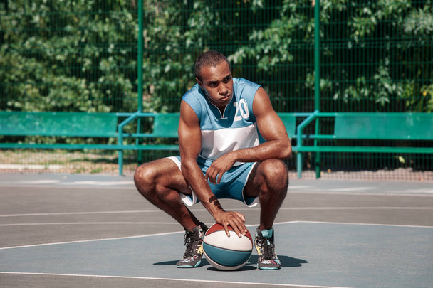 Picture of young resting african basketball player - Foto, afbeelding
