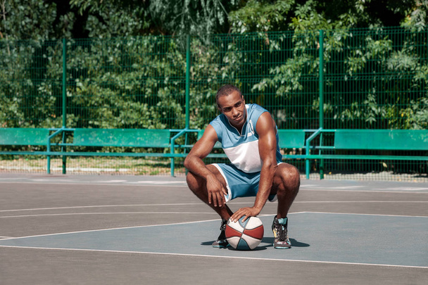 Picture of young resting african basketball player - Fotografie, Obrázek