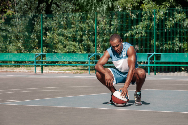 Picture of young resting african basketball player - 写真・画像