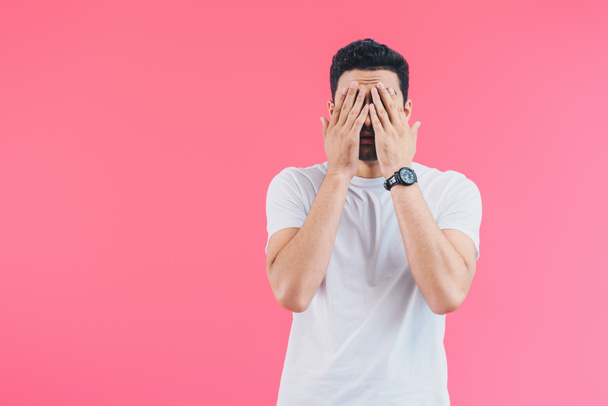 tired man closing eyes with hands isolated on pink - Photo, Image