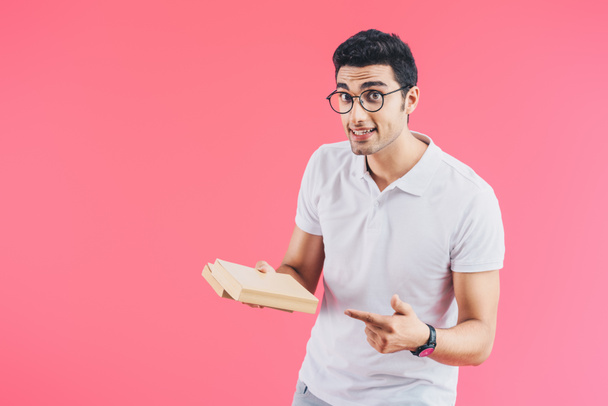 excited handsome student pointing on books isolated on pink - Φωτογραφία, εικόνα