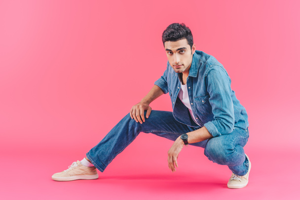 stylish man posing in denim clothes on pink background - Foto, afbeelding