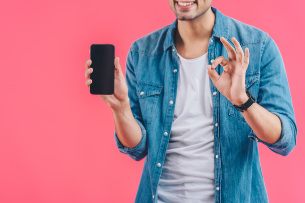 partial view of young man doing ok sign and showing smartphone with blank screen isolated on pink - Φωτογραφία, εικόνα