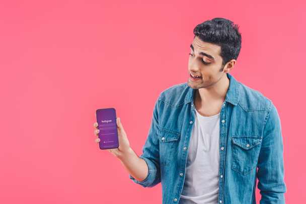 young man showing smartphone with instagram website isolated on pink - Φωτογραφία, εικόνα