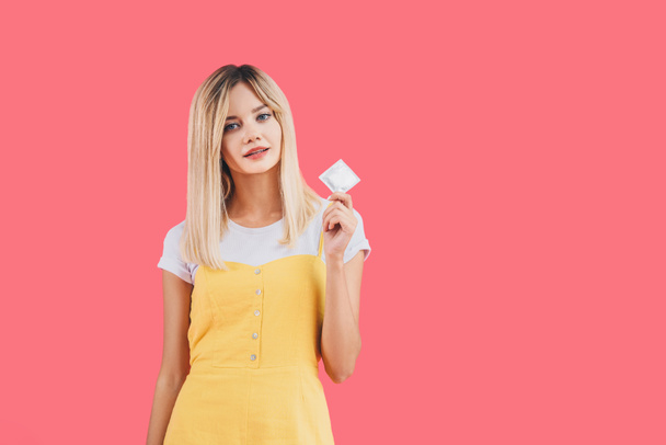 young stylish woman holding condom isolated on pink - Zdjęcie, obraz