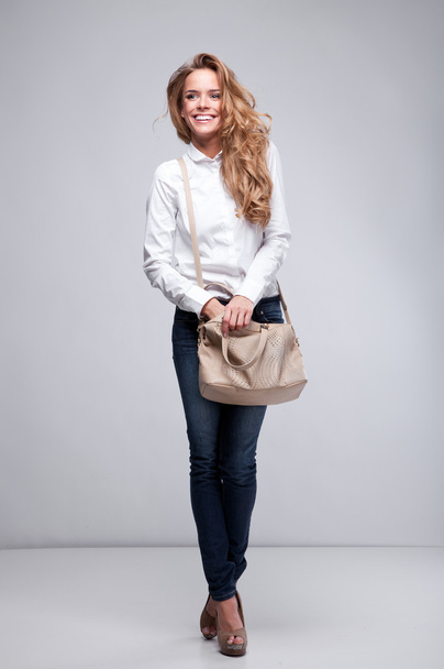 Beautiful happy woman holding a bag - Foto, Imagem