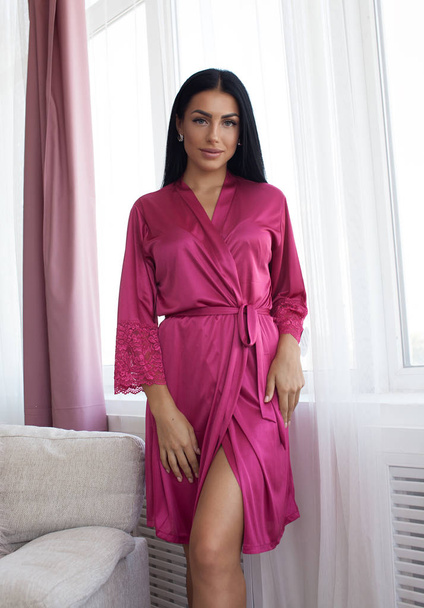 Beautiful sexy woman wear silk pajama style casual girl with dark hair fashion catalog lady perfect face cosmetic and body makeup meeting walk interior room. - Foto, Bild