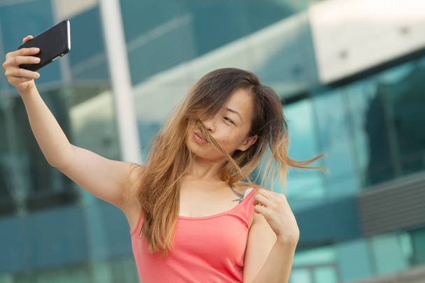 Portraits of Pretty Beautiful Asian woman taking a photo by selfie in urban. - Fotoğraf, Görsel