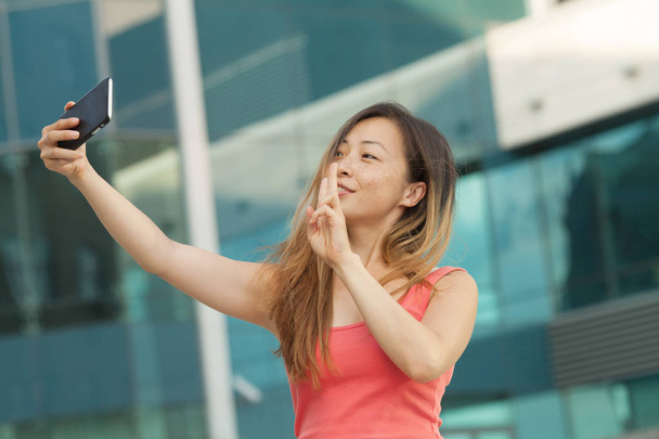 Portraits of Pretty Beautiful Asian woman taking a photo by selfie in urban. - Foto, Imagem